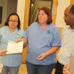 Helen Bouman, RN, speaks to store manager