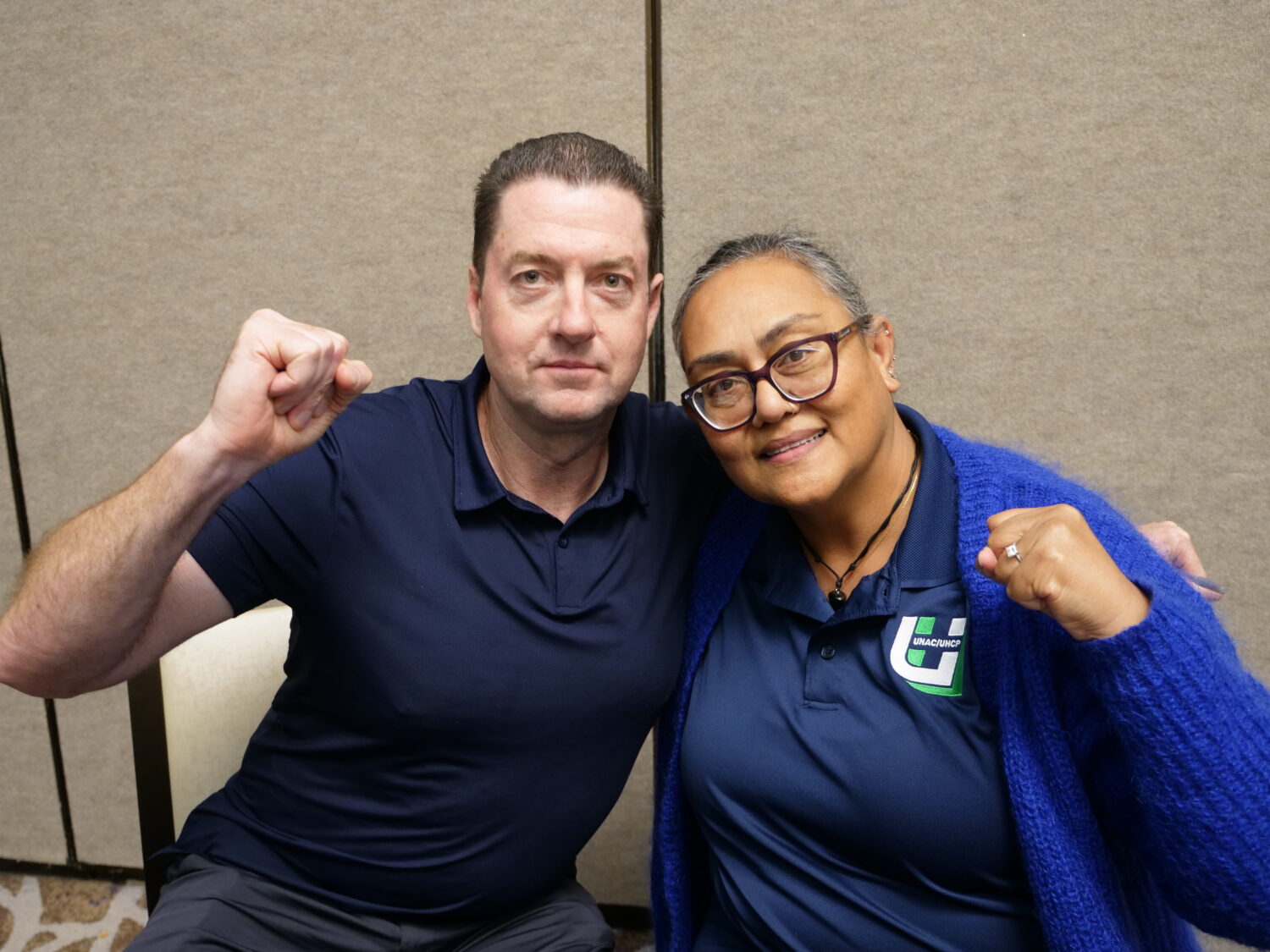 Two nurses have fist up and smile